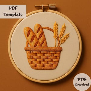 May include: A brown wicker basket filled with two loaves of bread and three stalks of wheat. The basket is in a wooden embroidery hoop on a brown background.