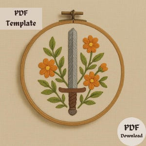 May include: Embroidered design in a wooden hoop featuring a sword, orange flowers, and green leaves. The sword is gray, the flowers are orange, and the leaves are green. The text "PDF Template" and "PDF Download" are visible.