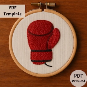 May include: An embroidery hoop with a red boxing glove design. The glove is stitched with textured thread and features black accents. The text "PDF Template" and "PDF Download" are visible.