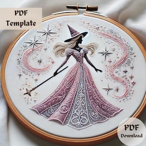 May include: Embroidered hoop art featuring a silhouette of a witch in a pink gown and hat, holding a wand. The design includes stars and a crescent moon, with the text "PDF Template" and "PDF Download". The artwork is set in a wooden embroidery hoop.