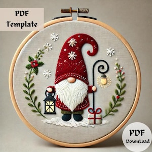 May include: Embroidered Christmas gnome with a red hat, white beard, and a lantern. The gnome is holding a lamppost with a light bulb. The design is on a beige fabric in a wooden embroidery hoop.