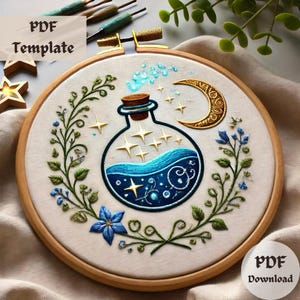 May include: Embroidered hoop art featuring a blue glass bottle filled with a swirling blue liquid and gold stars. The bottle is surrounded by green leaves and blue flowers. A crescent moon is in the top right corner of the hoop.
