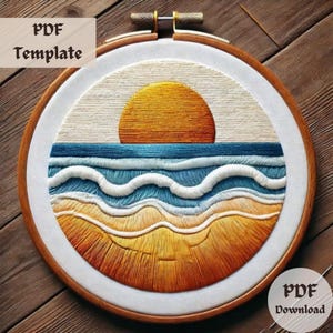 May include: A circular embroidery hoop with a white fabric background featuring a sunset over the ocean. The sun is a bright orange and yellow, the ocean is blue and white, and the sand is a light brown and yellow.