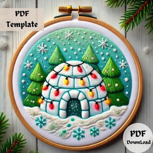 May include: Embroidered hoop art featuring a white igloo with colorful lights, surrounded by green pine trees and snowflakes on a blue and green background. The text "PDF Template" is in the top left corner and "PDF Download" is in the bottom right corner.