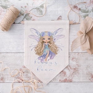 May include: A white canvas banner featuring a whimsical illustration of a fairy with blue wings and a flower crown. The banner reads "Poppy's Room" in purple script.
