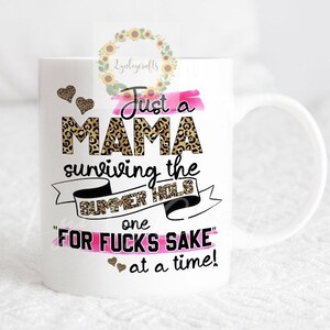 May include: White ceramic mug with a pink and black design. The text reads "Just a Mama surviving the Summer Hols one FOR FUCK'S SAKE at a time!"