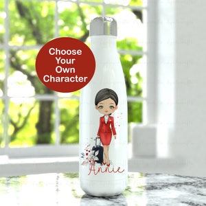 May include: White stainless steel water bottle featuring a cartoon illustration of a flight attendant carrying a suitcase. The bottle has a red and white floral design and the name "Annie" printed at the bottom.