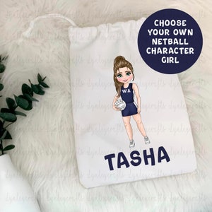 May include: A white drawstring bag featuring a cartoon illustration of a girl playing netball. The girl is wearing a blue and white netball kit with the letters "WA" on the front. She is holding a white netball and has brown hair and blue eyes. The bag has the name "TASHA" printed in black letters below the illustration. The text "CHOOSE YOUR OWN NETBALL CHARACTER GIRL" is printed in black letters on a white circle in the top right corner of the bag.