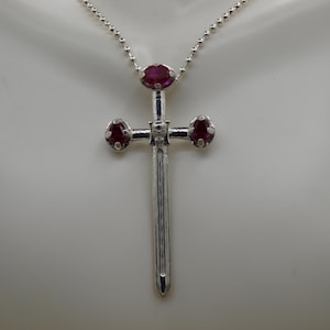 92.5 Medieval Sword Pendant set with Two 5x7mm and one 7x9mm Very Fine Lab Rubies, 92.5, 18in Chain Included. Measures: 67mm L x 12.5mm W.