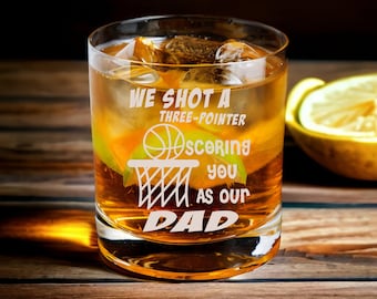 May include: A clear glass with a basketball and net design. The glass has the text "We shot a three-pointer scoring you as our Dad" etched on it.