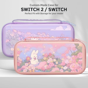 Pode incluir: Duas capas Switch 2 / Switch. A capa superior é lavanda com um design floral. A capa inferior é rosa com um design de coelho e floral. O texto na parte superior diz "Custom-Made Case for SWITCH 2 / SWITCH".