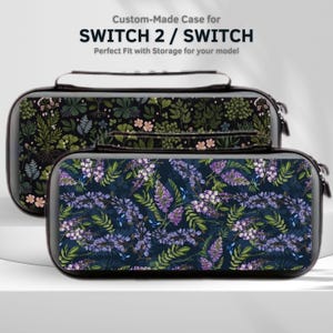 May include: Two custom-made cases for SWITCH 2 / SWITCH. The cases feature floral patterns. One case has a dark background with green and pink flowers. The other case has a dark background with purple flowers and green leaves. The cases have a handle and zipper.