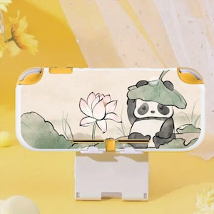 May include: A white and yellow Nintendo Switch Lite case featuring a panda bear under a leaf, a lotus flower, and green foliage. The case has a landscape design with a yellow background.