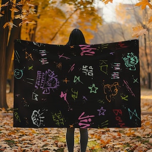 May include: Black throw blanket with a colorful graffiti pattern featuring words like "Tuff Life", "Born", and "Vin".