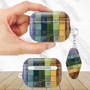 May include: AirPods case and keychain with a colorful mosaic tile design. The case is rectangular with rounded edges, and the keychain is a matching teardrop shape. The tiles feature shades of blue, green, yellow, and brown.