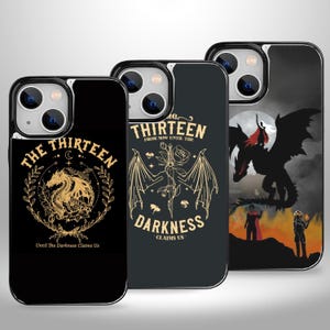 May include: Three black phone cases with different designs. The first case features a gold dragon with the text "The Thirteen" and "Until The Darkness Claims Us". The second case features a gold dagger with wings and the text "The Thirteen From Now Until The Darkness Claims Us". The third case features a black dragon with a person riding it and the text "The Thirteen".