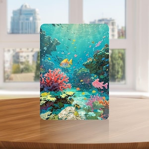 May include: A rectangular print featuring a vibrant underwater coral reef scene with bright pink and orange coral formations, various small tropical fish in yellow, orange, and pink, and a clear blue ocean background with light rays filtering down.