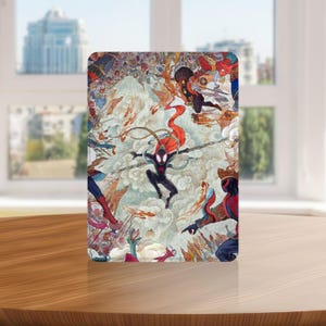 May include: A rectangular art print featuring a dynamic illustration of multiple Spider-Man characters in action. The artwork showcases a central figure in a black suit with a red cape, surrounded by other costumed figures and stylized clouds. The color palette includes reds, blues, and oranges.