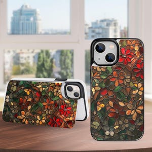 Könnte beinhalten: Eine Handyhülle mit floralem Muster und schwarzem Rand. Das Design zeigt rote, orangefarbene und grüne Blumen mit braunen Akzenten. Die Hülle wird offen und geschlossen gezeigt und zeigt die Kamera des Telefons.