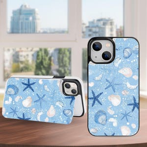 May include: A light blue phone case with a seashell and starfish pattern. The case features a black border and a white interior. The design includes blue starfish, white and blue seashells, and white speckles. The phone case is displayed on a wooden surface.