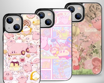 May include: Three phone cases with black borders, each featuring a different design. One case has a pink and white pattern with cartoon characters and desserts. Another has a comic-style design with pink and blue characters. The third case has a pink floral and musical note design.
