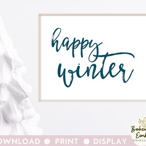 May include: A framed print with the words "happy winter" in teal script on a white background. The print is in a white frame. A white decorative tree is on the left side of the image.
