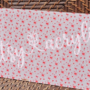 May include: A white sheet of acrylic with a red splatter pattern. The sheet is translucent and has a subtle sheen.