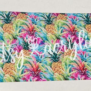 May include: A rectangular print featuring a vibrant tropical pattern of pineapples and foliage in shades of yellow, green, pink, and blue. The words "artsy acrylic" are written in white script across the print.