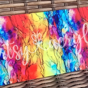 May include: Abstract art painting on a rectangular canvas with a rainbow color scheme of red, orange, yellow, green, blue, and purple. The painting features black lines and swirls throughout the canvas.