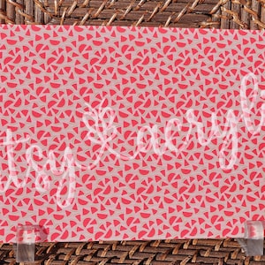 May include: A sheet of pink and white patterned paper with a repeating design of watermelon slices. The paper is perfect for crafting and scrapbooking.