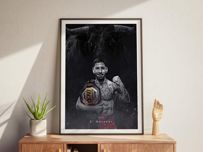 May include: A black and white poster featuring a mixed martial arts fighter holding a championship belt. The fighter is standing in front of a bull with red eyes. The text "El Matador" is at the bottom of the poster.