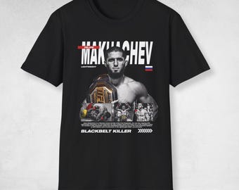 May include: A black t-shirt featuring a graphic print of Islam Makhachev with the text "ISLAM MAKHACHEV", "LIGHTWEIGHT", and "BLACKBELT KILLER". The design includes a Russian flag, a UFC championship belt, and three smaller action photos of the fighter.