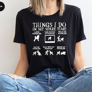 a woman sitting on the floor wearing a t - shirt that says things i do