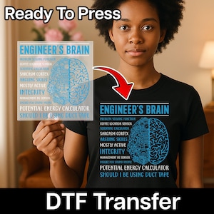 May include: Black t-shirt with the text "ENGINEER'S BRAIN" and a brain graphic. The shirt also features a list of humorous engineering-related functions and phrases. The words "Ready To Press" and "DTF Transfer" are also visible.