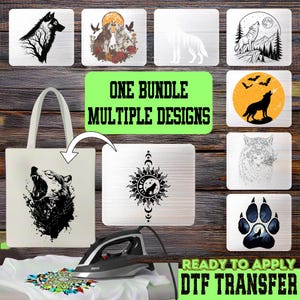 May include: A collection of wolf-themed DTF transfers featuring various black and white or colored illustrations of wolves, moons, and nature scenes. A white tote bag displays a wolf head graphic, and a black iron sits on a white fabric surface.