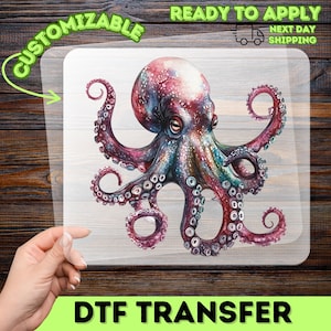 May include: A vibrant octopus DTF transfer in a watercolor style. The octopus features shades of pink, purple, and blue, with detailed tentacles. The transfer is labelled "CUSTOMIZABLE" and "READY TO APPLY".