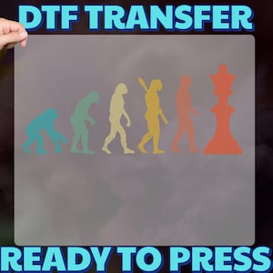 May include: DTF transfer with the text "DTF TRANSFER" and "READY TO PRESS". The design shows the evolution of man leading to a chess piece. The figures are in shades of blue, green, yellow, orange, and red.