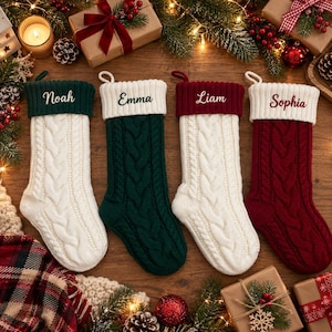 May include: Four cable-knit Christmas stockings with folded cuffs. The first is white with a dark green cuff labeled Noah, the second is dark green with a white cuff labeled Emma, the third is white with a dark red cuff labeled Liam, and the fourth is dark red with a white cuff labeled Sophia.
