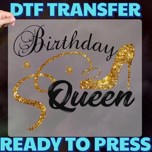 May include: DTF transfer with the text "Birthday Queen" in black script, featuring a gold glitter high heel and accents. The words "DTF TRANSFER" and "READY TO PRESS" are in blue.
