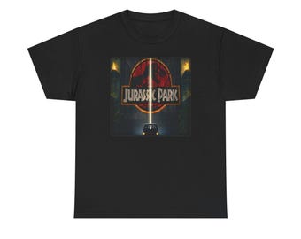 May include: Black t-shirt featuring a rectangular graphic with the text "JURASSIC PARK" in gold lettering. The graphic includes a red circle with a vertical light beam and a vehicle silhouette.