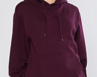 May include: A burgundy hoodie with a drawstring hood and a kangaroo pocket. The sweatshirt is made of a soft material and has a relaxed fit. The image shows the upper body of the hoodie, with the hood up and the drawstring visible.