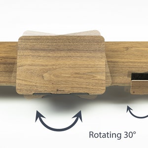 May include: A wooden laptop stand with a rotating feature. The stand is shown rotating 30 degrees. The stand is made of wood with a natural finish.  Rotating 30&deg;