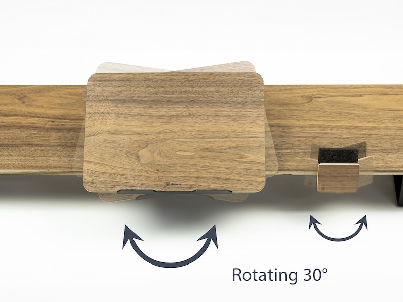 May include: A wooden laptop stand with a rotating feature. The stand is shown rotating 30 degrees. The stand is made of wood with a natural finish.  Rotating 30&deg;