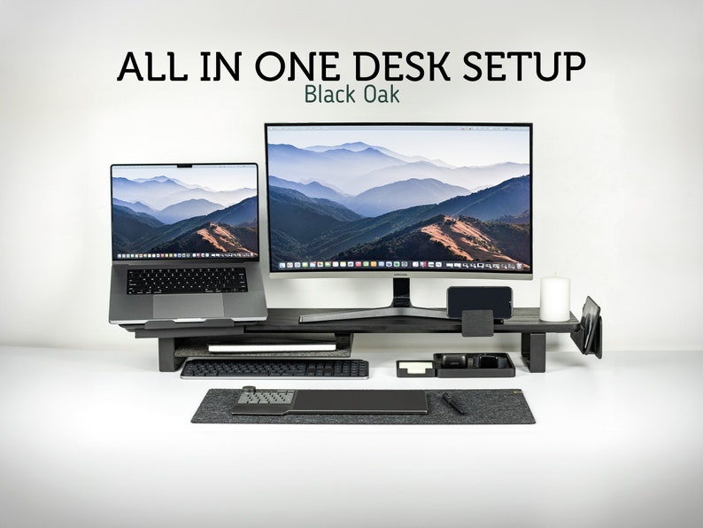 May include: A black oak desk setup with a laptop, monitor, keyboard, mouse, and phone stand. The monitor and laptop are displaying a mountain landscape. The text "ALL IN ONE DESK SETUP" and "Black Oak" is displayed at the top of the image.