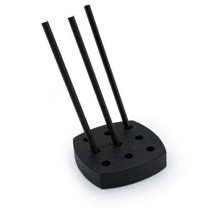 May include: Black wooden stand with six holes for holding drinking straws. Three black straws are inserted into the stand.