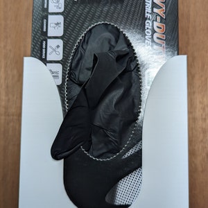 May include: A box of black nitrile gloves labeled "Heavy-Duty Black Nitrile Gloves". The box has a black and white textured background with white text. The gloves are non-latex, fully textured, non-powdered, disposable, ambidextrous, non-sterile, and for single use only.