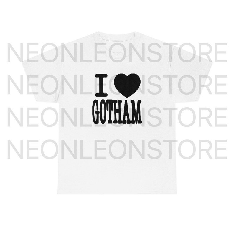 May include: White t-shirt with the phrase "I &hearts; GOTHAM" printed in black. The heart symbol is solid black. The shirt is a classic crew neck style.