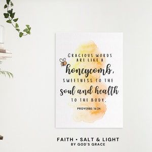 May include: A watercolor print with a yellow and orange background featuring a bee and the quote "Gracious words are like a honeycomb, sweetness to the soul and health to the body. Proverbs 16:24". The print also includes the text "Faith Salt & Light By God's Grace".