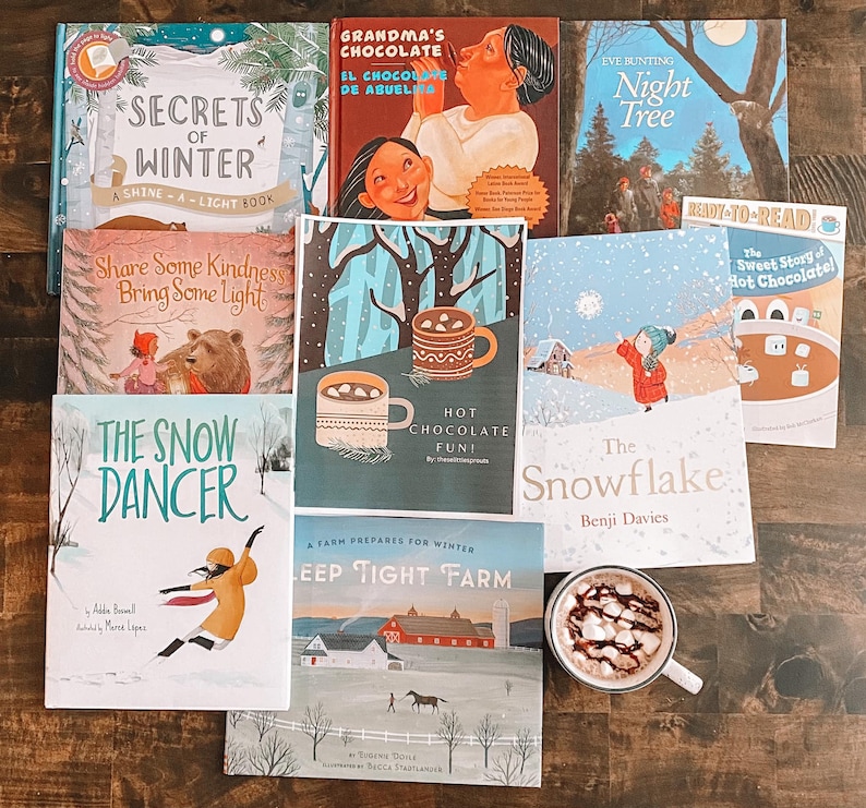 K&ouml;nnte beinhalten: Eine Sammlung von Kinderb&uuml;chern mit Wintermotiven, darunter "Secrets of Winter", "The Snow Dancer", "The Snowflake", "Hot Chocolate Fun!" und "The Sweet Story of Hot Chocolate".