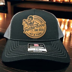 Surviving Fatherhood Leather Patch Hat | Funny Beer Drinking Custom Trucker Hat | Gift For Him Unique | Richardson 112 or Flexfit Hat